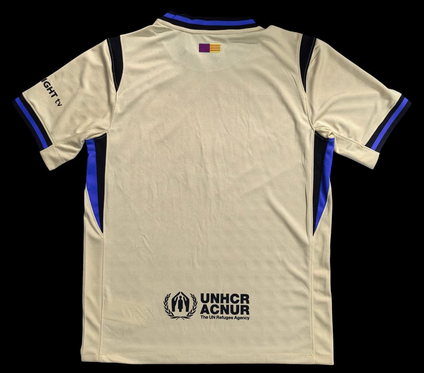 Maillot de football My Store 4, beige, col et manches bleus et noirs, logo UNHCR ACNUR au dos. Tissu respirant.