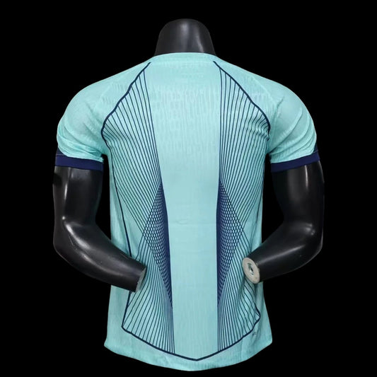 My Store 4 Maillot de football homme bleu sarcelle avec lignes graphiques bleues contrastantes et col bleu marine.