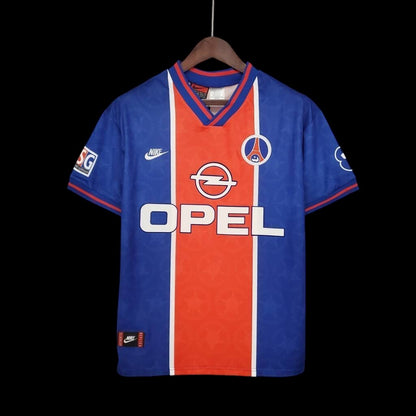 Maillot de football vintage bleu roi et orange My Store 4 avec logo Opel et Nike, inspiré des années 90.