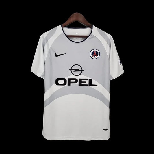 Maillot de football vintage Paris Saint-Germain gris clair avec logo Opel et touches bleues. Tissu léger et respirant.