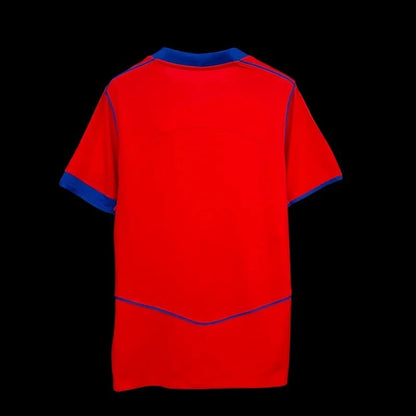 Maillot de football homme My Store rouge vif avec accents bleu électrique, tissu respirant, coupe classique.