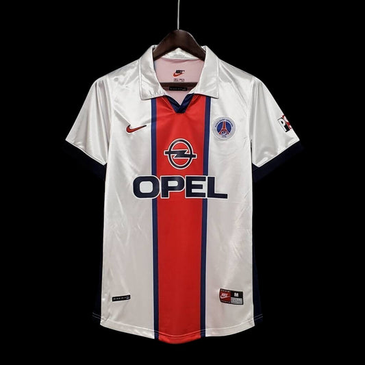 Maillot de football vintage blanc My Store, avec bande centrale rouge, logo Opel et manches bleu marine.